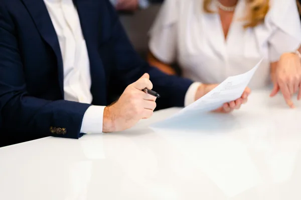 Two people reviewing the details in a document