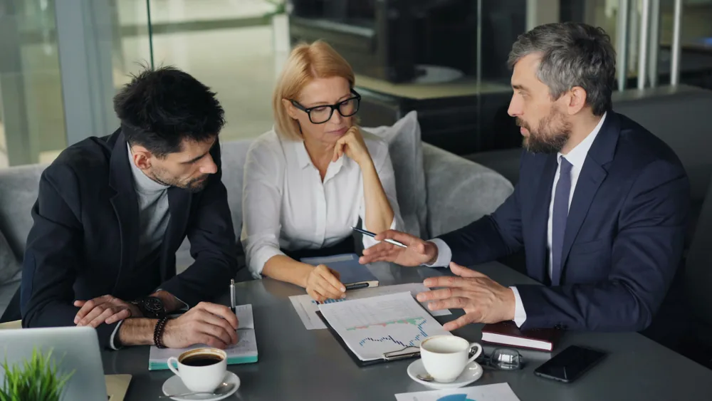 An advisor walking two people through financial documents